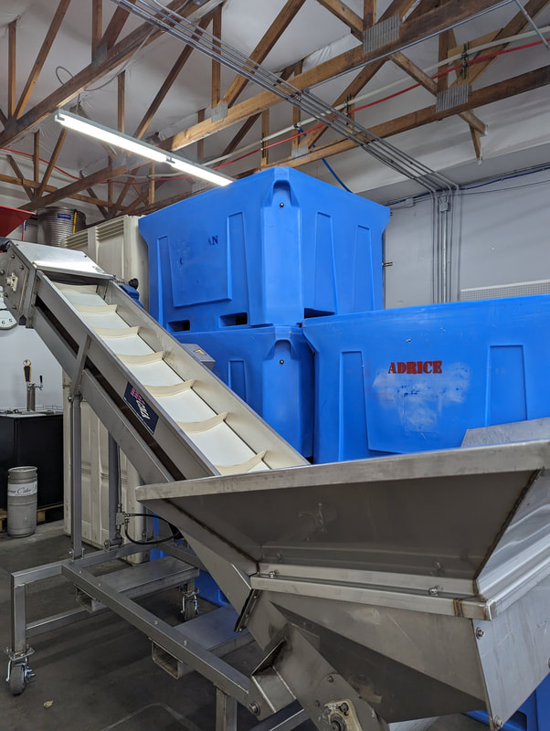 Fermenting bins and grape conveyor.